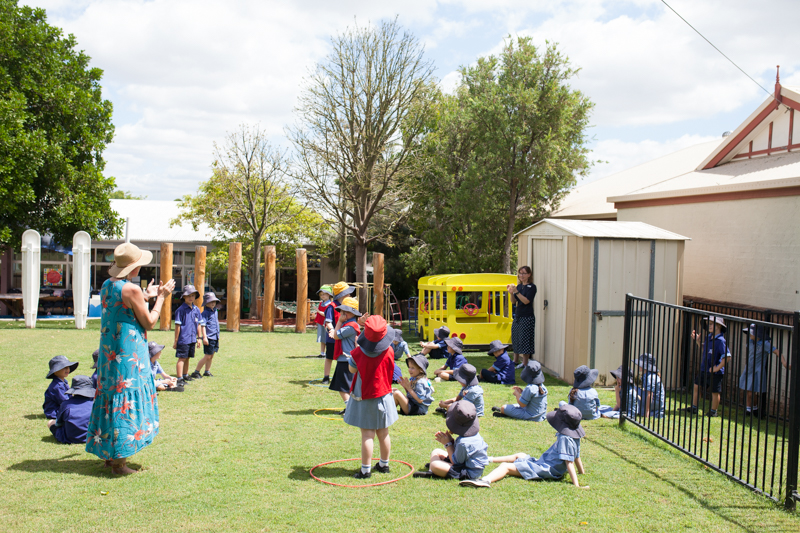 Students taking part in an outdoor learning activity on school grounds.