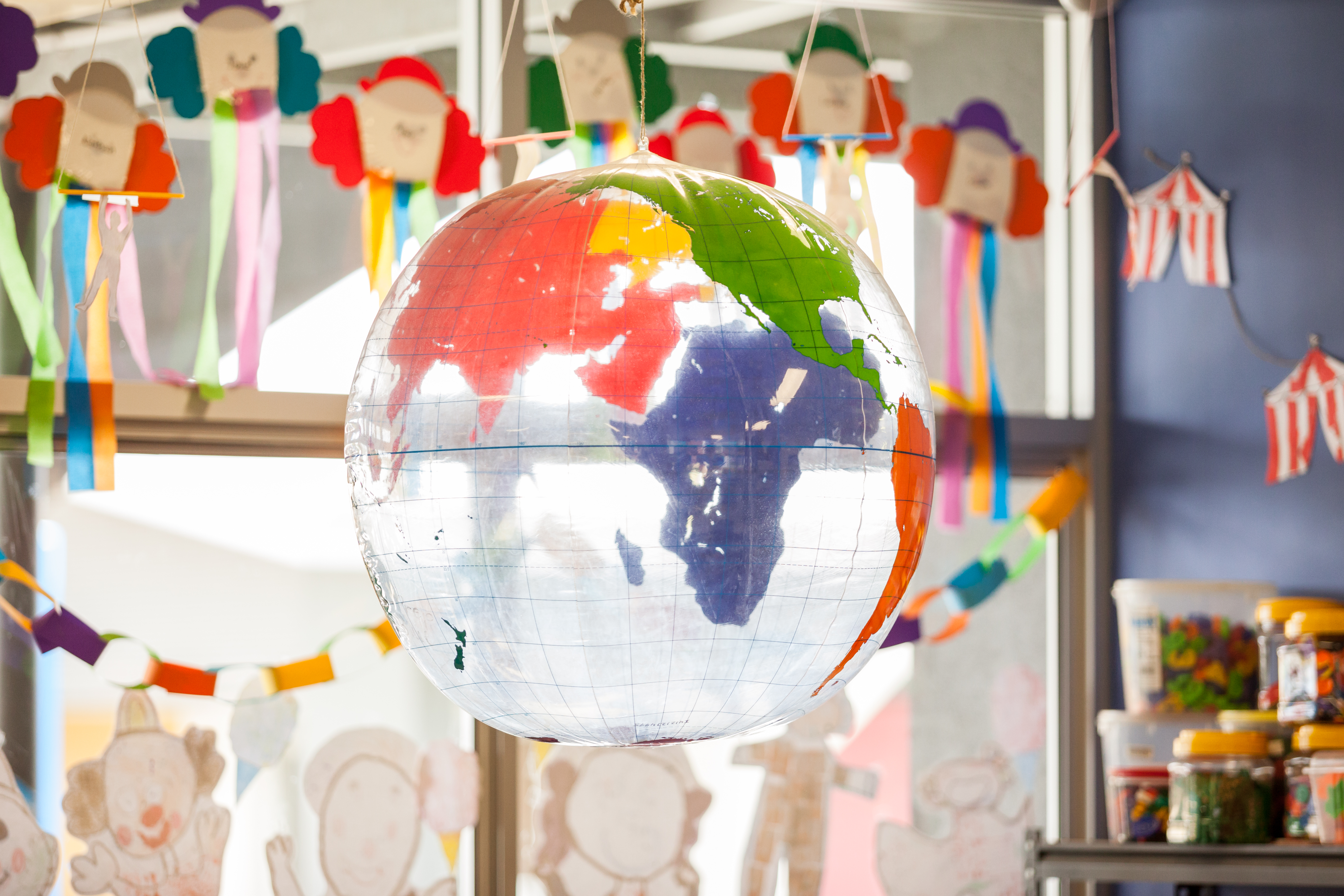 Hanging globe artwork created by students in a classroom.
