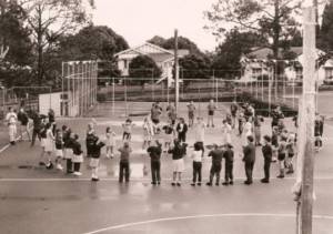 Archival photograph of students participating in an outdoor playground activity.